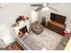 Living room boasts a fireplace, gray sofas, ceiling fan and a decorative rug at 208 Summer Chase, Carrollton, GA 30116