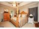 A cozy bedroom featuring a ceiling fan, four-poster bed, and stylish decor at 208 Summer Chase, Carrollton, GA 30116