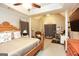 Spacious bedroom featuring a wooden four-poster bed and office area at 208 Summer Chase, Carrollton, GA 30116
