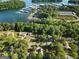 Picturesque aerial view of lakeside properties with nearby boat docks nestled amongst mature, lush green trees at 1875 Bernice Dr, Cumming, GA 30041
