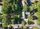 Overhead shot of the home and yard showcasing the home's roof, landscaping, driveway, and surrounding mature trees at 1875 Bernice Dr, Cumming, GA 30041