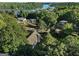 Aerial view of the property nestled among mature trees, highlighting its proximity to a lake and recreational area at 1875 Bernice Dr, Cumming, GA 30041