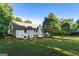 Spacious backyard featuring a lush lawn, mature trees, and the home's rear elevation at 1875 Bernice Dr, Cumming, GA 30041
