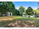 Extensive backyard with mature trees and an outbuilding, offering plenty of space for outdoor activities and storage at 1875 Bernice Dr, Cumming, GA 30041