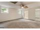 Spacious basement bedroom with neutral carpet and light-filled windows to the outside at 1875 Bernice Dr, Cumming, GA 30041