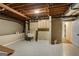 Unfinished basement featuring concrete floor, exposed beams, utility sink, storage cabinets and access to additional rooms at 1875 Bernice Dr, Cumming, GA 30041