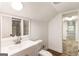 Bright, clean bathroom with modern vanity, mirror, and shower with stone tiles at 1875 Bernice Dr, Cumming, GA 30041