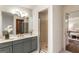 Elegant bathroom featuring double sinks, sleek gray cabinetry, and modern fixtures for a luxurious experience at 1875 Bernice Dr, Cumming, GA 30041