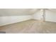 A bright bedroom featuring neutral carpet, angled ceilings, and a doorway at 1875 Bernice Dr, Cumming, GA 30041