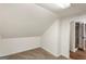 Cozy carpeted room with slanted ceiling and a bathroom right off of the bedroom at 1875 Bernice Dr, Cumming, GA 30041