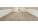 A bright bedroom featuring neutral carpet, angled ceilings, and a doorway at 1875 Bernice Dr, Cumming, GA 30041