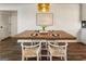 Dining area featuring a wood table with seating and a modern light fixture at 1875 Bernice Dr, Cumming, GA 30041