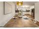 Dining area with a wood table and bright light fixture next to a modern kitchen at 1875 Bernice Dr, Cumming, GA 30041