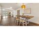 Open-concept dining area featuring a wood table, stylish chandelier, and access to the outdoors at 1875 Bernice Dr, Cumming, GA 30041