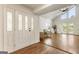 Bright, airy foyer with hardwood floors, and a glimpse into the living area at 1875 Bernice Dr, Cumming, GA 30041