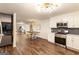An open-concept kitchen with modern appliances and a view to the dining and living rooms at 1875 Bernice Dr, Cumming, GA 30041