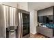 Contemporary kitchen with stainless steel refrigerator and custom storage solutions, maximizing space and appeal at 1875 Bernice Dr, Cumming, GA 30041