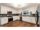 Modern kitchen features white cabinets, stainless steel appliances, and sleek finishes at 1875 Bernice Dr, Cumming, GA 30041