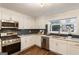 Modern kitchen features white cabinets, stainless steel appliances, and contrasting backsplash at 1875 Bernice Dr, Cumming, GA 30041