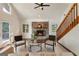 Bright living room featuring a stone fireplace, hardwood floors and vaulted ceiling at 1875 Bernice Dr, Cumming, GA 30041