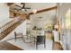 Bright living room features vaulted ceilings, exposed wood beams, and an open staircase at 1875 Bernice Dr, Cumming, GA 30041