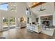 An airy open living room features hardwood floors and a cozy stone fireplace at 1875 Bernice Dr, Cumming, GA 30041