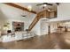 Large open-concept living room with hardwood floors, stone fireplace, and a staircase at 1875 Bernice Dr, Cumming, GA 30041