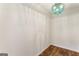 Minimalist room showcasing light-colored walls and flooring, highlighted by a unique and stylish teal chandelier at 1875 Bernice Dr, Cumming, GA 30041
