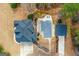Aerial view showcasing a home with a pool and pool house, surrounded by landscaped grounds and mature trees at 1202 Persimmon Way, Mcdonough, GA 30252
