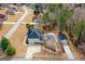 Aerial shot of home with a well-manicured lawn, pool, and pool house in a serene neighborhood at 1202 Persimmon Way, Mcdonough, GA 30252
