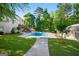 Lush backyard featuring a pool, patio, deck and detached building at 1202 Persimmon Way, Mcdonough, GA 30252