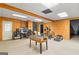 Basement room with carpet featuring foosball table, workout machines, and wood paneled walls at 1202 Persimmon Way, Mcdonough, GA 30252