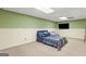 Finished basement bedroom with bed, television, and paneled walls at 1202 Persimmon Way, Mcdonough, GA 30252