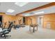 Basement room with carpet featuring foosball table, workout machines, and wood paneled walls at 1202 Persimmon Way, Mcdonough, GA 30252