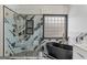 Luxurious bathroom featuring a glass shower, standalone tub, and stylish tile accents at 1202 Persimmon Way, Mcdonough, GA 30252