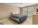 Bedroom featuring neutral carpet and a large window bringing in lots of sunlight at 1202 Persimmon Way, Mcdonough, GA 30252