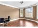 Bright bedroom featuring beautiful hardwood floors, ample natural light, and neutral paint at 1202 Persimmon Way, Mcdonough, GA 30252