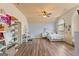 Bright bedroom features wood floors, a ceiling fan, desk, and a large window at 1202 Persimmon Way, Mcdonough, GA 30252