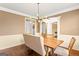 Dining room showcasing modern lighting, wood floors, and classic wainscoting, perfect for gatherings at 1202 Persimmon Way, Mcdonough, GA 30252