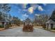 Gated community entrance featuring brick and stone structures with a well-maintained landscape at 1202 Persimmon Way, Mcdonough, GA 30252