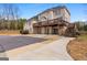 The rear exterior of this home features a spacious deck with steps down to a covered pool area at 1202 Persimmon Way, Mcdonough, GA 30252