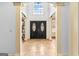 Grand foyer with large double doors, high ceilings, tile flooring, and elegant architectural details at 1202 Persimmon Way, Mcdonough, GA 30252