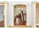 Inviting living room featuring elegant columns, a cozy seating area, and a staircase with iron railings at 1202 Persimmon Way, Mcdonough, GA 30252