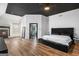 Spacious main bedroom with a black accent ceiling, cozy fireplace, and ensuite bathroom at 1202 Persimmon Way, Mcdonough, GA 30252