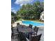 Outdoor pool, patio area and backyard with an outdoor dining area at 1202 Persimmon Way, Mcdonough, GA 30252