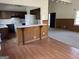 An open kitchen with dark wood cabinets, white appliances, and a dining area with hardwood floors at 2195 Wilson Nw Rd, Conyers, GA 30012