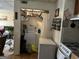 A view from the kitchen showing a laundry closet, shelving, and a washer and dryer unit at 2195 Wilson Nw Rd, Conyers, GA 30012