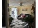 Cozy living room with patterned rug, ceiling fan, and a comfortable couch, filled with lots of plants at 2195 Wilson Nw Rd, Conyers, GA 30012