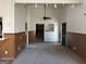 Cozy living room featuring wood paneling, neutral paint, a ceiling fan, and carpeting at 2195 Wilson Nw Rd, Conyers, GA 30012
