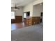 Open living room featuring wood paneling, ceiling fan, neutral paint, and luxury vinyl flooring at 2195 Wilson Nw Rd, Conyers, GA 30012